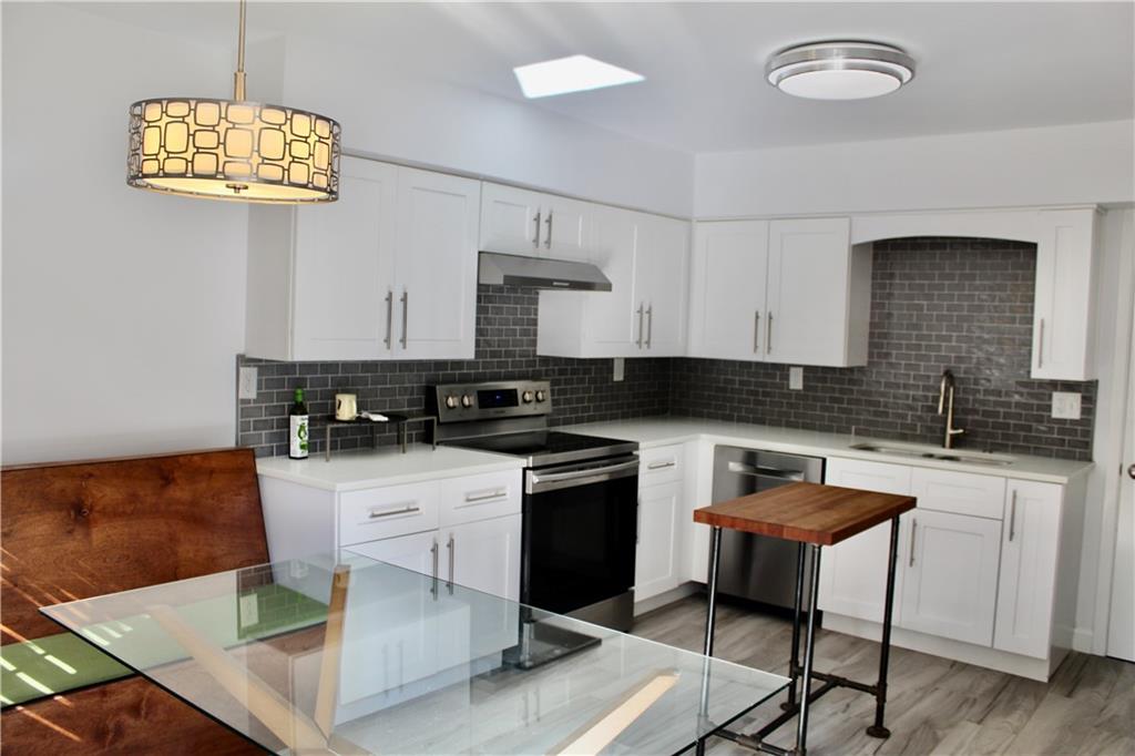 1191 Hampton Way Northeast Atlanta, GA 30324 - Photo 20 of 31 a kitchen with stainless steel appliances granite countertop a sink and cabinets