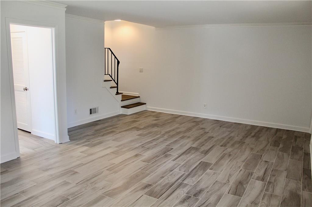 1191 Hampton Way Northeast Atlanta, GA 30324 - Photo 23 of 31 an empty room with wooden floor and entryway