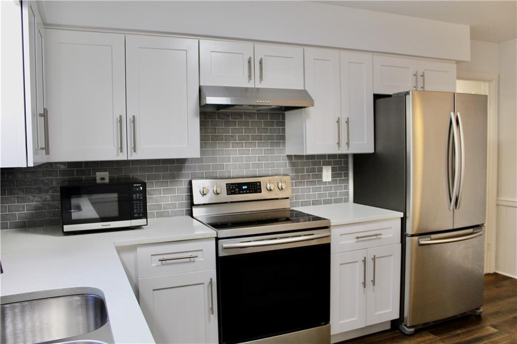 1191 Hampton Way Northeast Atlanta, GA 30324 - Photo 10 of 31 a kitchen with cabinets and stainless steel appliances