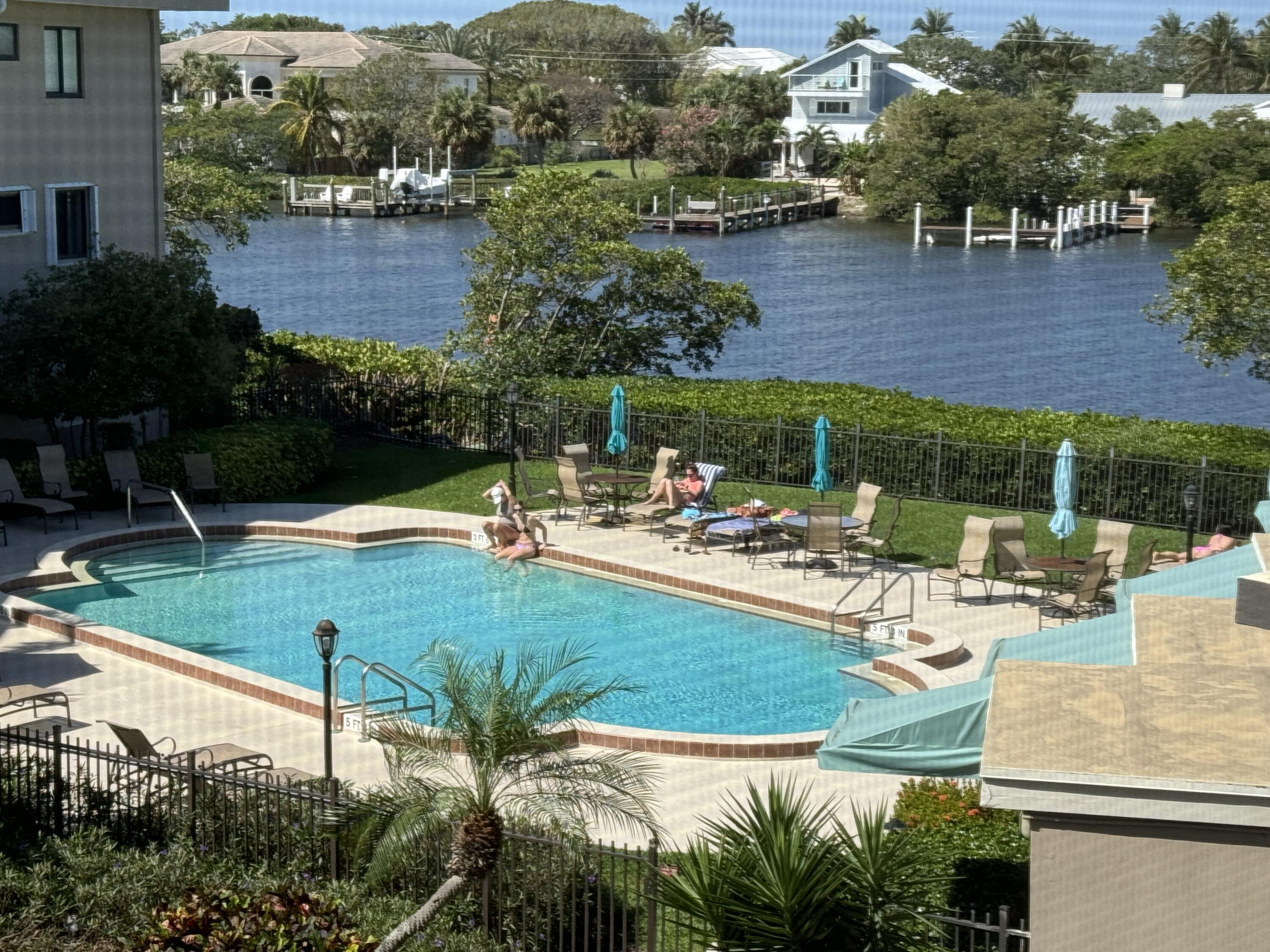 a view of a swimming pool and lounge chairs