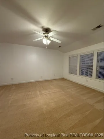 an empty room with a empty space and a ceiling fan