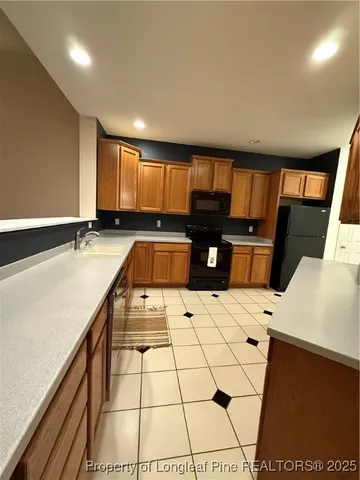a kitchen with a sink a stove and cabinets
