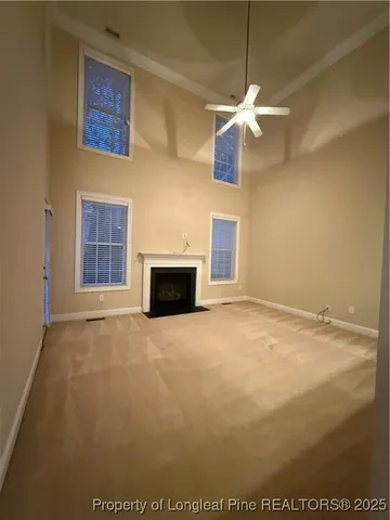 a view of empty room with a fireplace