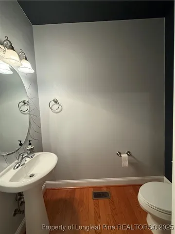 a bathroom with a sink toilet and a mirror