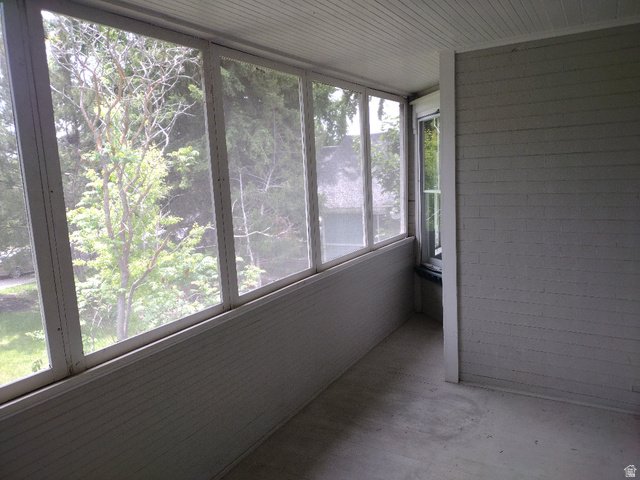 157 West 500 South Logan, UT 84321 - Photo 30 of 38 Screened-in porch featuring a beadboard ceiling, a window, and a wall of horizontal siding