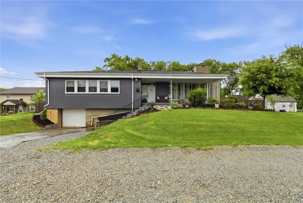 a front view of house with yard and green space