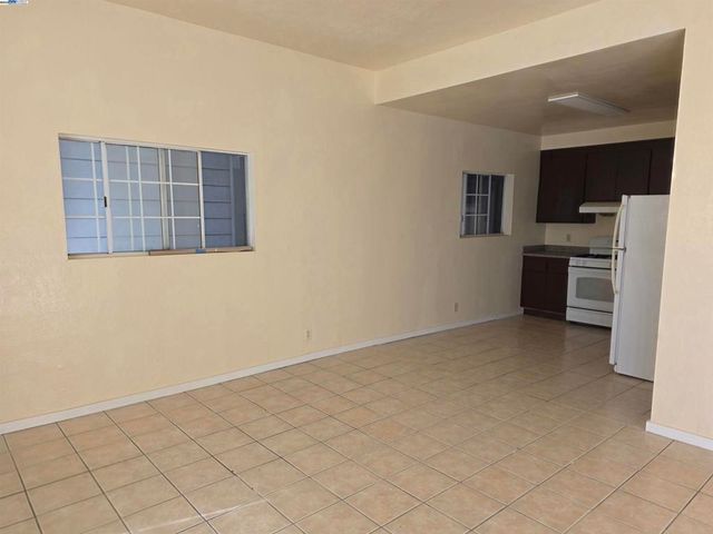 a view of kitchen with refrigerator cabinets and microwave
