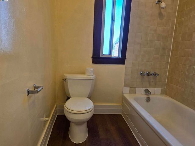 a bathroom with a toilet and a bathtub