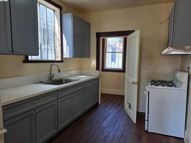 a kitchen with a sink a window and cabinets
