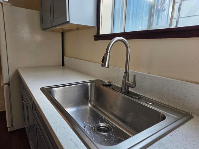 a kitchen with sink and cabinets