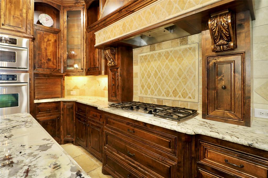 1609 Singletree Court McKinney, TX 75072 - Photo 13 of 38 a kitchen with stainless steel appliances granite countertop a sink and cabinets