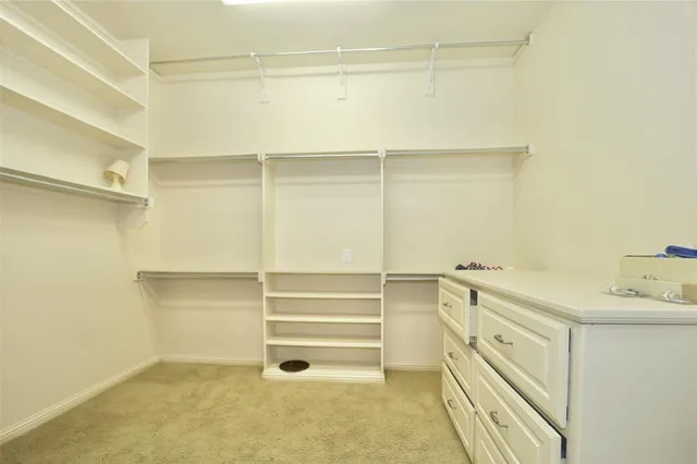 a view of walk in closet with empty racks