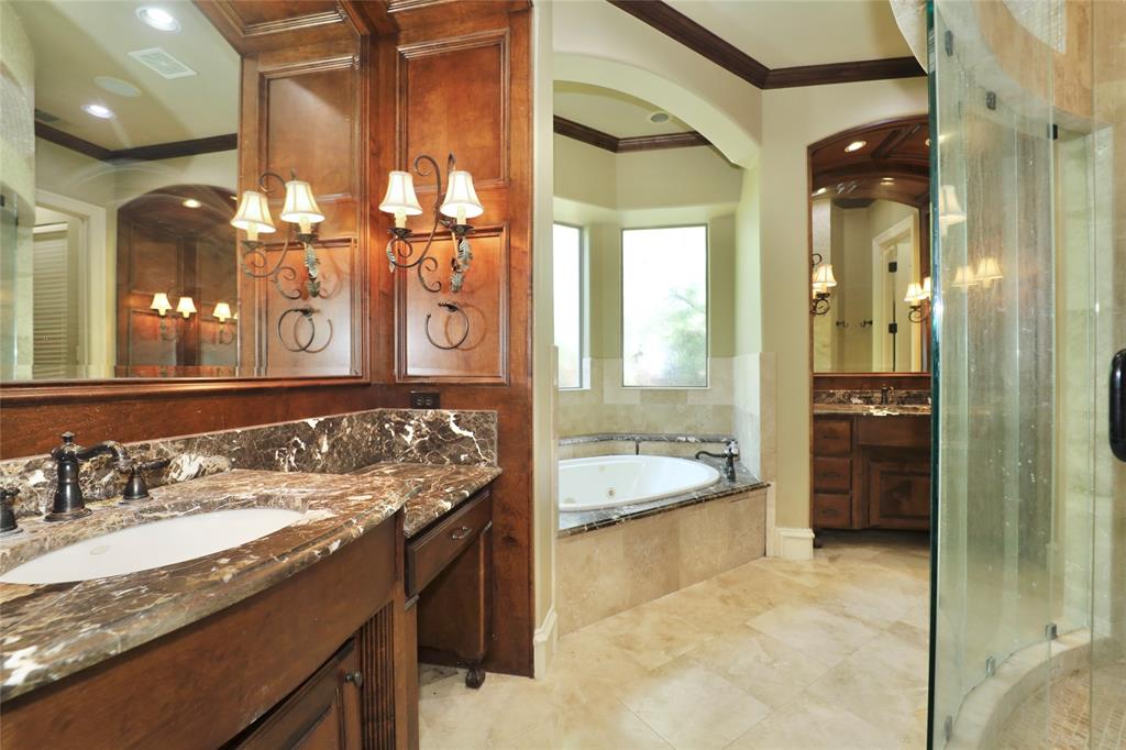 1609 Singletree Court McKinney, TX 75072 - Photo 18 of 38 a bathroom with a granite countertop sink a mirror and a shower
