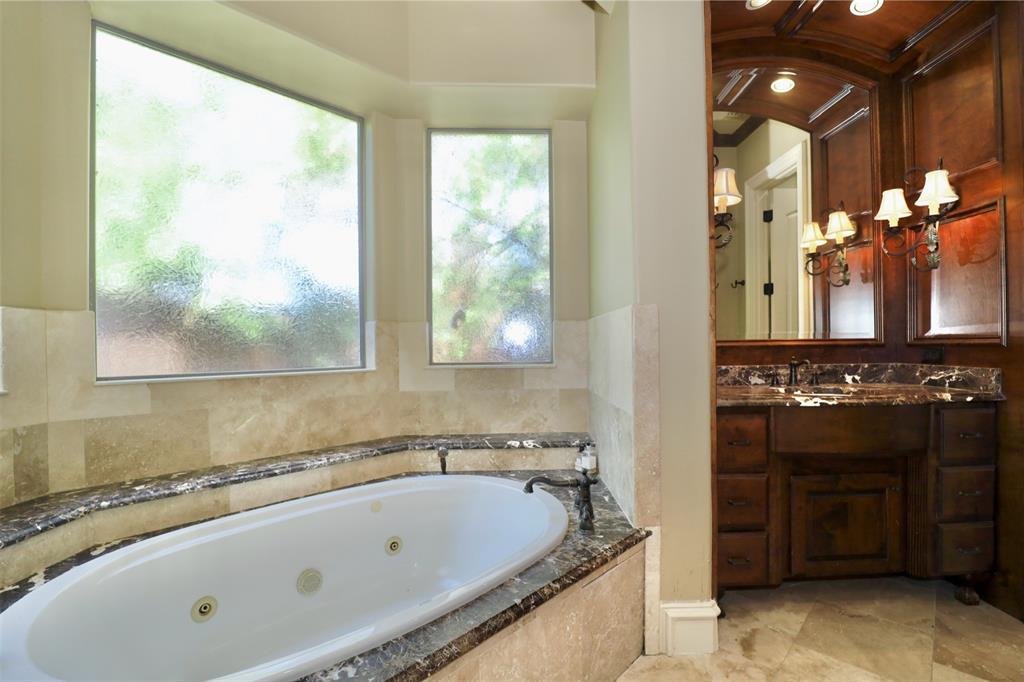 1609 Singletree Court McKinney, TX 75072 - Photo 19 of 38 a bathroom with a bathtub and a sink