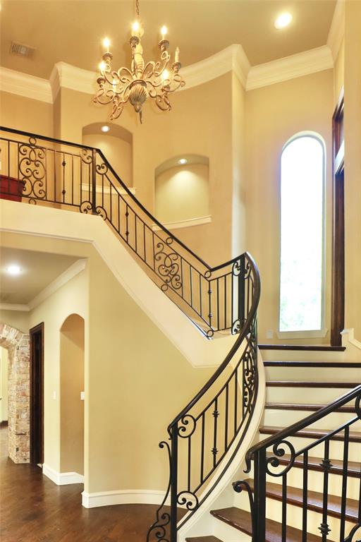 1609 Singletree Court McKinney, TX 75072 - Photo 21 of 38 a view of staircase with railing and a chandelier