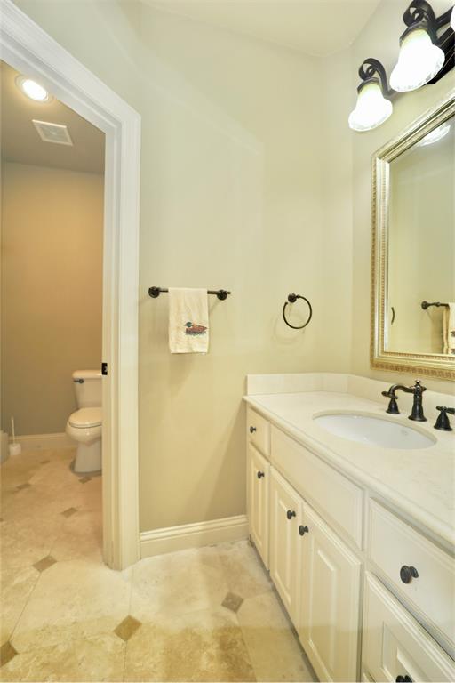 1609 Singletree Court McKinney, TX 75072 - Photo 30 of 38 a spacious bathroom with a double vanity sink a mirror and a toilet