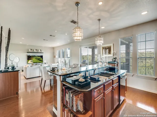 a kitchen that has a lot of cabinets and wooden floor