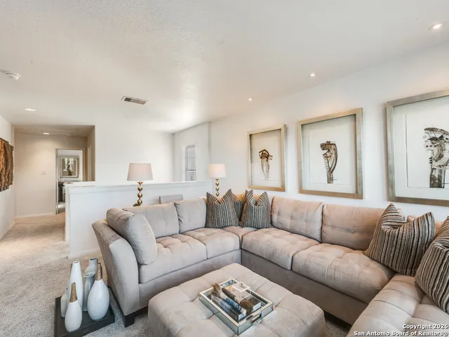 a living room with furniture white walls and a couch