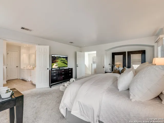 a spacious bedroom with a bed and a couch