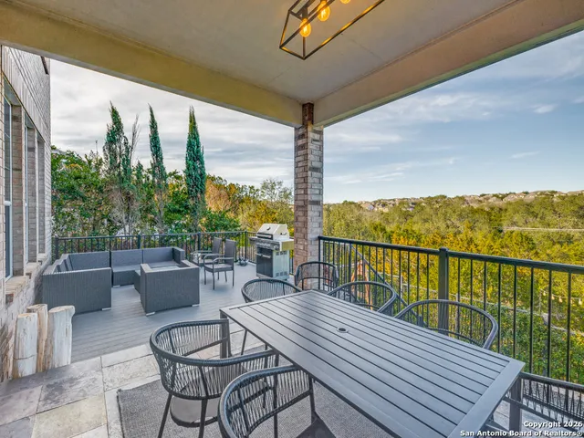 a view of a balcony with chairs and a potted plant