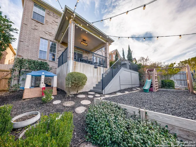 a view of a chair and table in the backyard