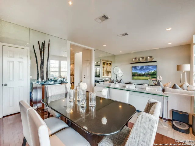 a large kitchen with a table and chairs