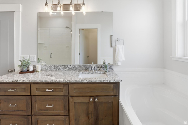1009 High Creek Road Cove, UT 84320 - Photo 33 of 79 Full bath with a stall shower, vanity, and a garden tub