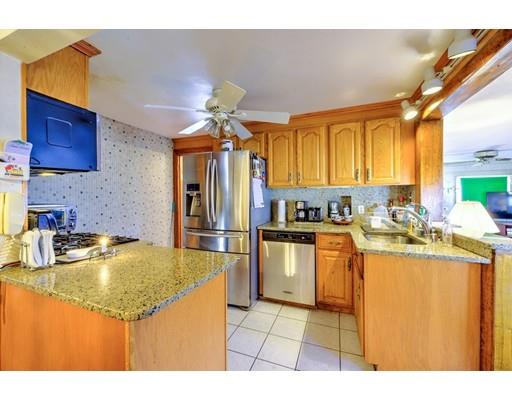 31 Kilburn Road Newton, MA 02465 - Photo 8 of 29 a kitchen with stainless steel appliances granite countertop a sink a stove and refrigerator