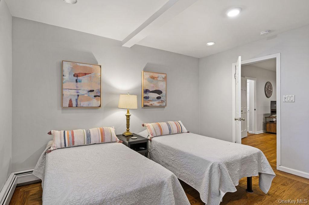 914 Wynnewood Road, Unit LL4 Pelham, NY 10803 - Photo 13 of 22 a bedroom with two beds and a painting on the wall