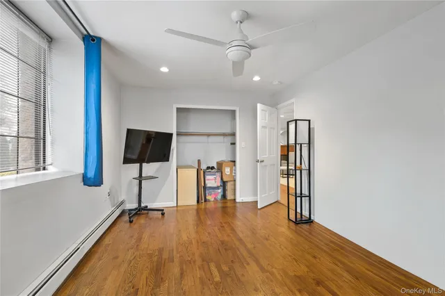 a view of a room with gym equipment and a flat screen tv