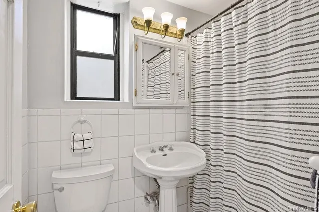 a bathroom with a sink a mirror and a toilet