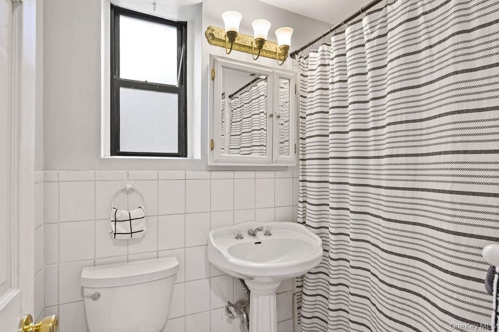 914 Wynnewood Road, Unit LL4 Pelham, NY 10803 - Photo 16 of 22 a bathroom with a sink a mirror and a toilet