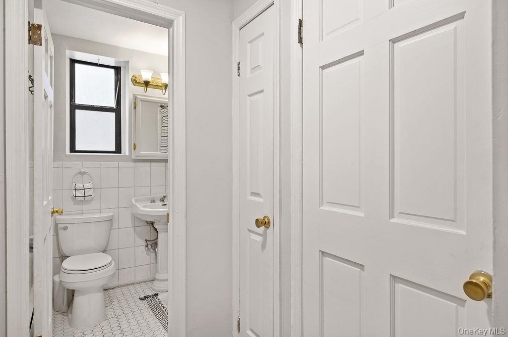 914 Wynnewood Road, Unit LL4 Pelham, NY 10803 - Photo 17 of 22 a bathroom with a toilet a sink and shower