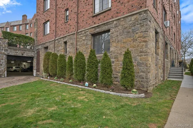 a view of a garden with brick walls