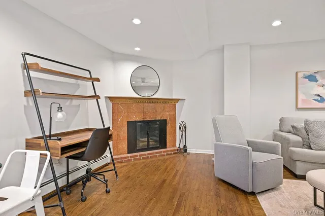 a living room with furniture a fireplace and wooden floor