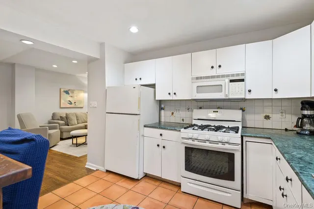 a kitchen with cabinets stainless steel appliances and a counter space