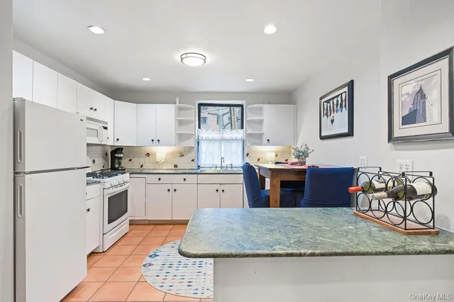 a kitchen with stainless steel appliances granite countertop a sink dishwasher stove top oven and refrigerator