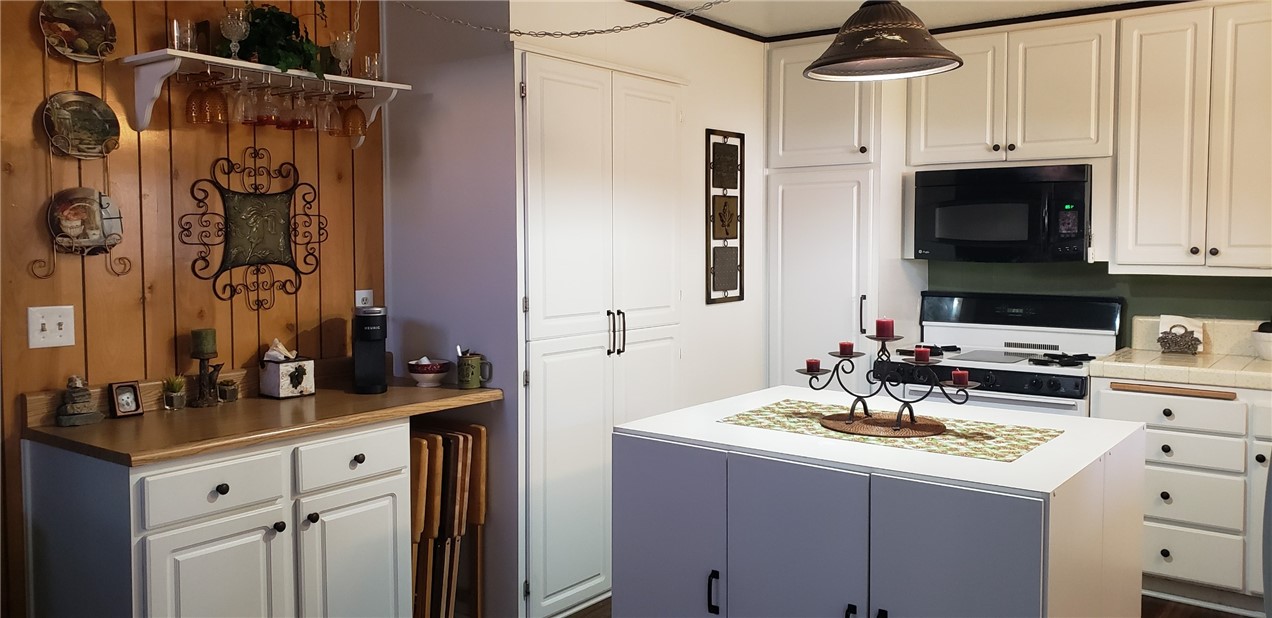 965 Snowbird Road Wrightwood, CA 92397 - Photo 12 of 28 a kitchen with a sink stove and cabinets