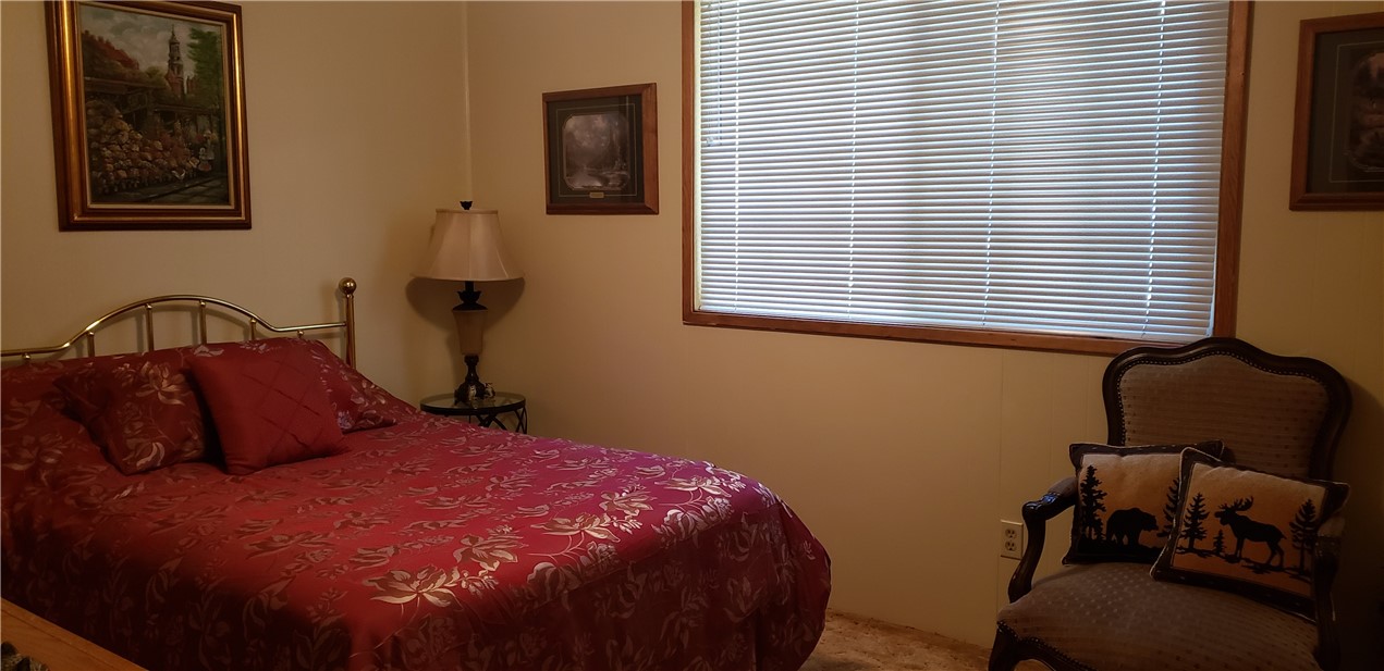 965 Snowbird Road Wrightwood, CA 92397 - Photo 15 of 28 a bedroom with a bed and chair with window