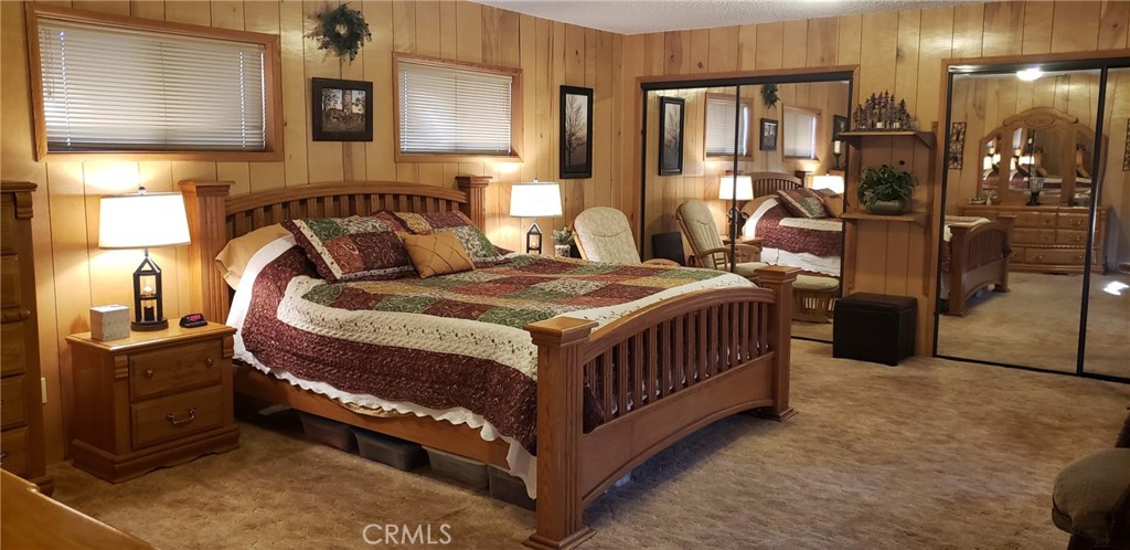 965 Snowbird Road Wrightwood, CA 92397 - Photo 20 of 28 a bedroom with bed and wooden floor