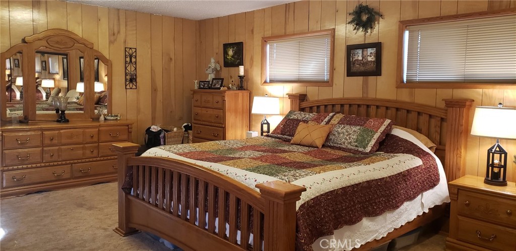 965 Snowbird Road Wrightwood, CA 92397 - Photo 21 of 28 a bedroom with a bed and a night stand
