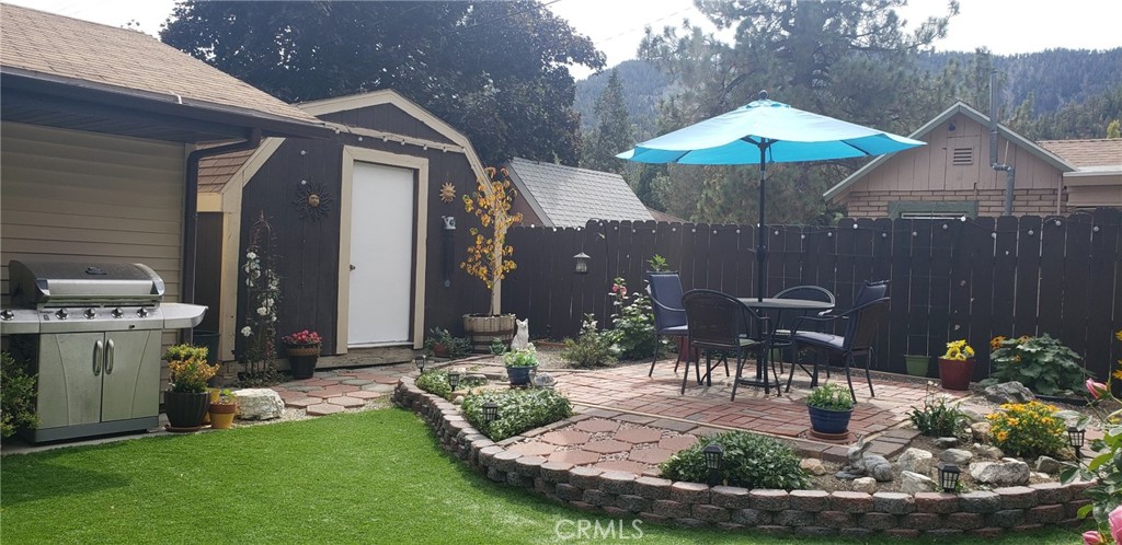965 Snowbird Road Wrightwood, CA 92397 - Photo 23 of 28 a view of a house with yard patio and furniture