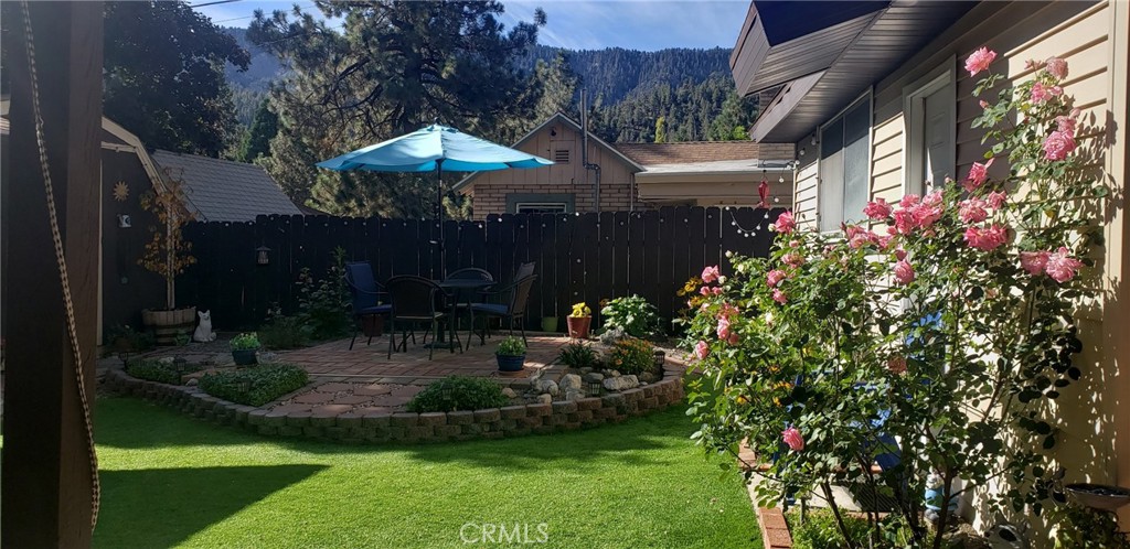 965 Snowbird Road Wrightwood, CA 92397 - Photo 27 of 28 a view of a patio with plants and a fountain