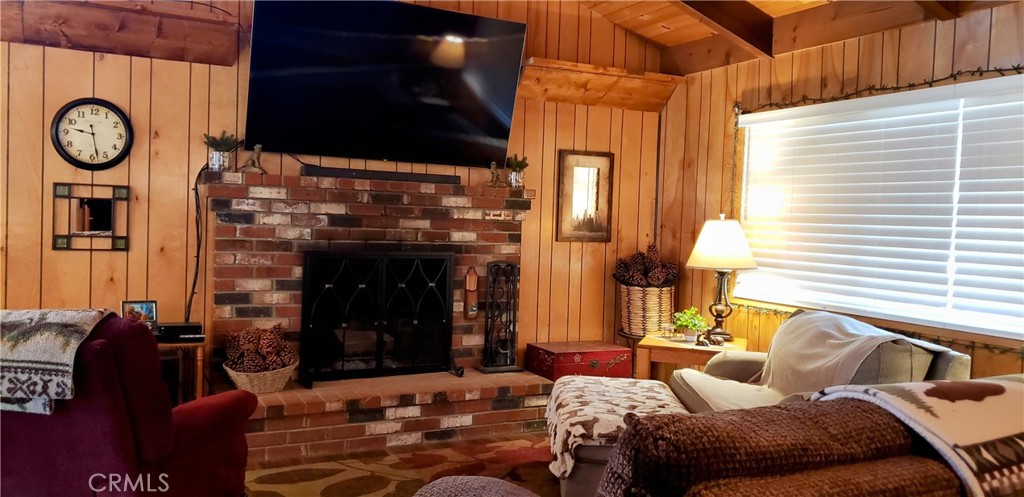 965 Snowbird Road Wrightwood, CA 92397 - Photo 5 of 28 a living room with furniture a fireplace and a window