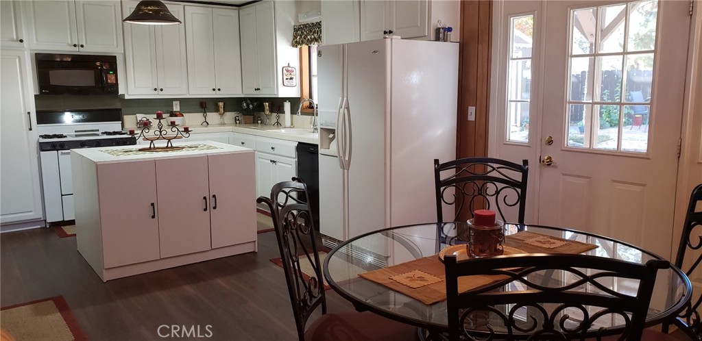 965 Snowbird Road Wrightwood, CA 92397 - Photo 7 of 28 a kitchen with a refrigerator a stove a sink and white cabinets