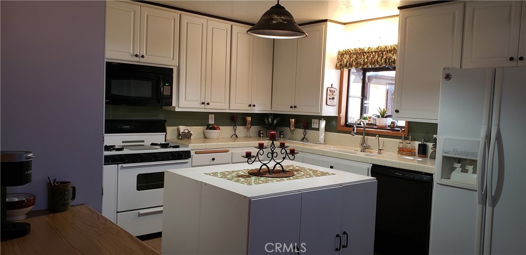965 Snowbird Road Wrightwood, CA 92397 - Photo 8 of 28 a kitchen with a sink stove and cabinets