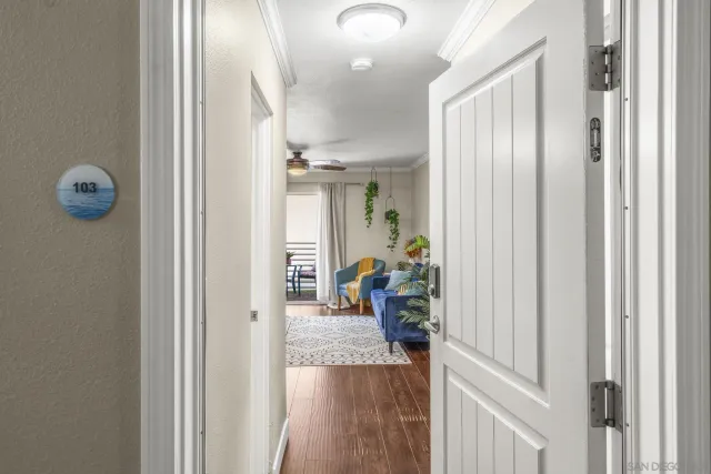 a view of hallway with livingroom and furniture