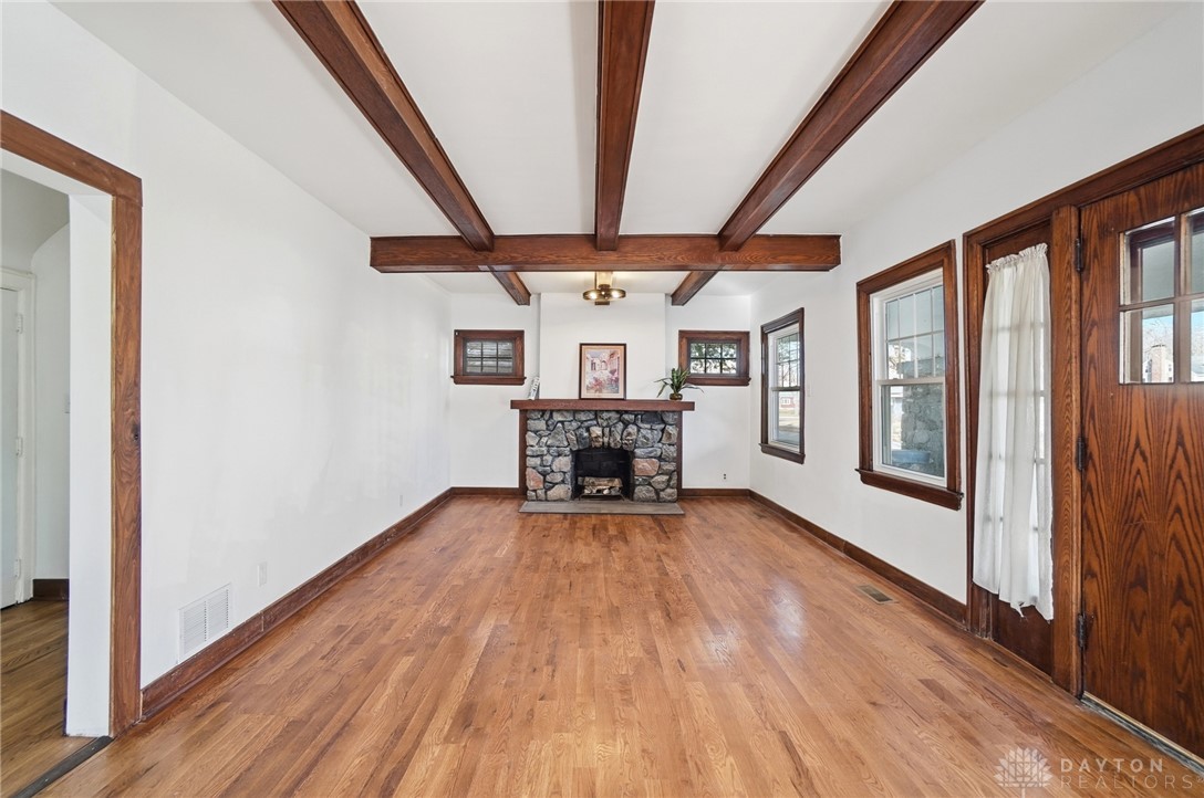 25 Englewood Road Springfield, OH 45504 - Photo 3 of 66 This inviting space features natural hardwood flooring and a classic stone fireplace.
