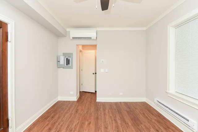 a view of a room with wooden floor