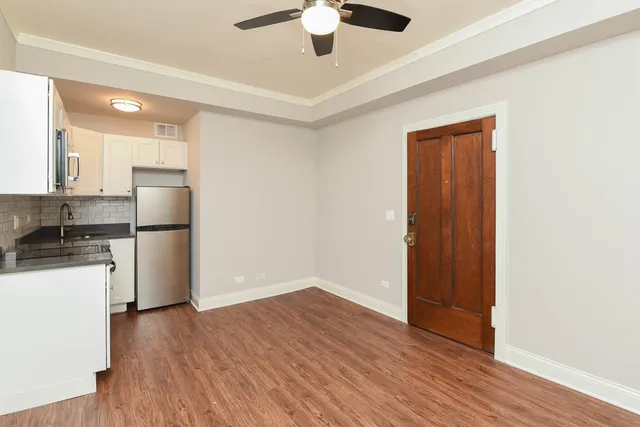 a kitchen with a refrigerator and a stove top oven